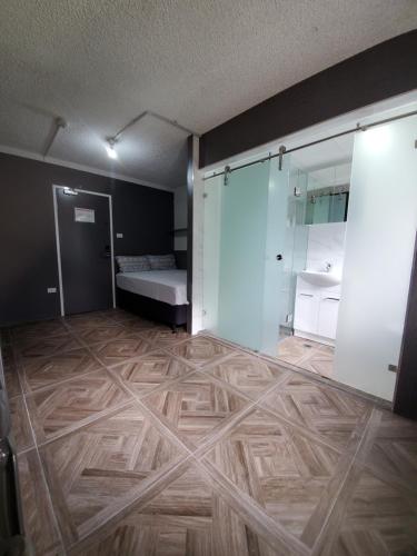 an empty room with a bed and a wooden floor at Seranin Bathurst in Bathurst
