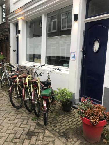 a row of bikes parked outside of a house at B&B Numero 14 in Amsterdam