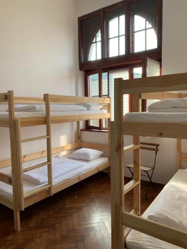 a room with three bunk beds and a window at VIKI Kazimierz in Kraków