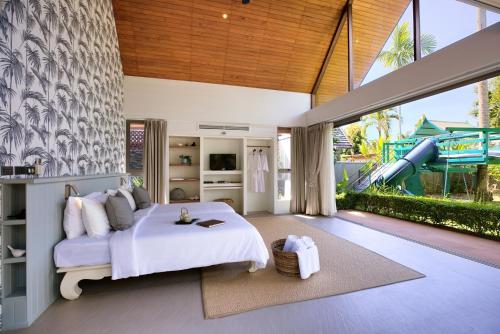 a bedroom with a bed and a slide at Baan Kilee in Lipa Noi