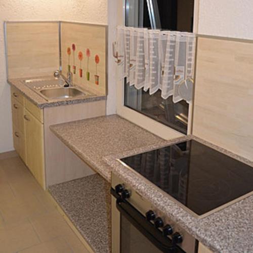 a kitchen with a sink and a stove top oven at FeWo Dana und Ralf in Nentershausen