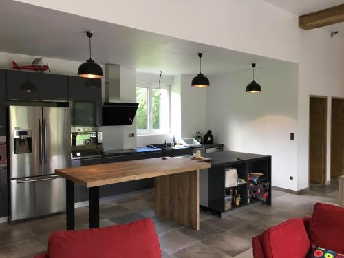 a kitchen with a wooden table in a room at Maison Eskola in Barcus