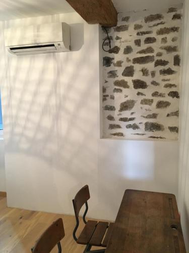 a dining room with a table and two chairs at Maison Eskola in Barcus