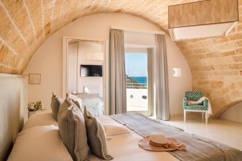 a bedroom with a bed with a view of the ocean at San Michele Suite in Polignano a Mare
