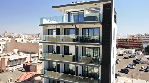 a building with balconies on the side of it at Jimmy's Suites in Larnaka