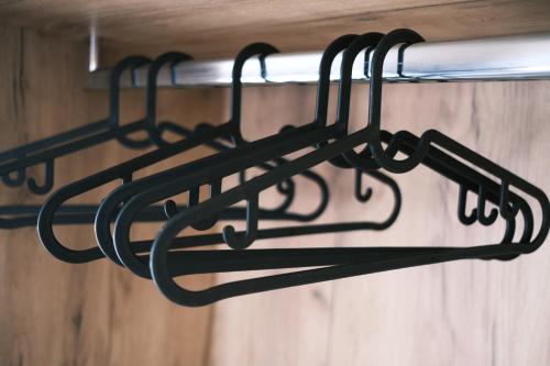 a black towel rack hanging from a wall at cobalt aqua in Iraklitsa