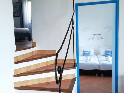 a staircase leading to a living room with a couch at Résidence Belvedere de Palombaggia in Porto-Vecchio