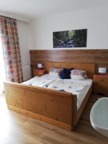 a bedroom with a wooden bed with two night stands at Haus Seppi in Neukirchen am Großvenediger