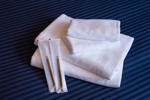 two white towels sitting on top of a table at HOTEL&CO in Fukuoka