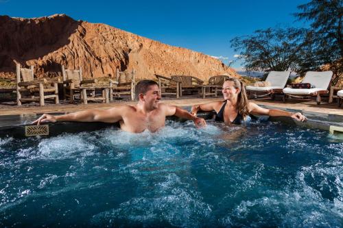 a man and a woman in a hot tub at Nayara Alto Atacama in San Pedro de Atacama