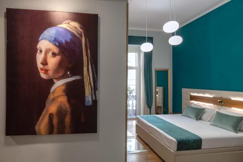 a bedroom with a painting of a woman with a head at Hotel Paba in Rome