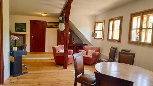 a living room with a table and chairs at Farma Hermína in Jilemnice