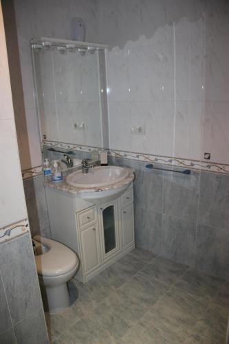 a bathroom with a sink and a toilet at Piso céntrico en Miño. in Miño