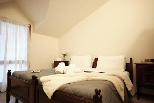 a bedroom with a large bed with white pillows at Albergo Trattoria Speranza in Foza