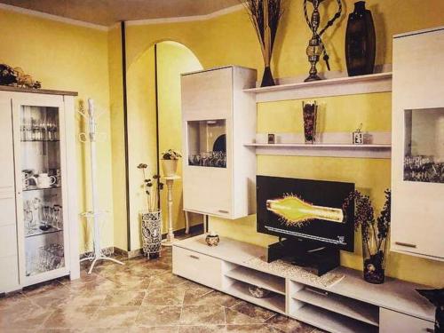 a living room with a fireplace and white cabinets at Casa vacanze valledoria in Valledoria