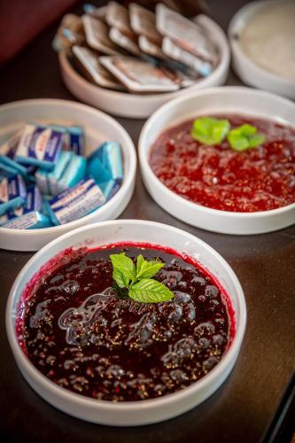 a table with four bowls of black beans and sauce at Wellness Hotel ABÁCIE in Nový Jičín