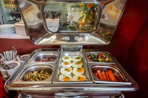 a tray of food with eggs and vegetables at Wellness Hotel ABÁCIE in Nový Jičín