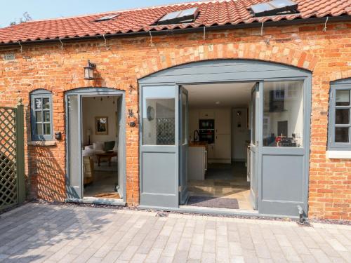 an open garage door on a brick building at The Coach House in Sleaford