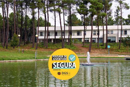 a sign in the water in front of a building at HI Melgaco - Pousada de Juventude in Melgaço