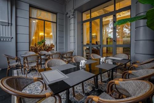 a row of tables and chairs on a patio at AVS Hotel Phu Quoc in Phu Quoc