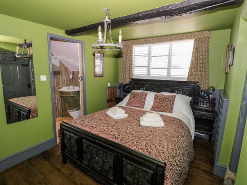 sypialnia z dużym łóżkiem i lustrem w obiekcie The Old Paper Shop w mieście Tewkesbury