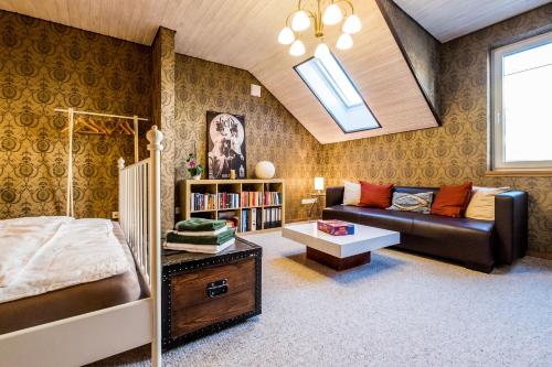 a bedroom with a bed and a couch at Wohlfühloase mit Blick auf Trier in Trier