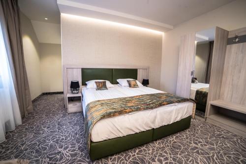 a hotel room with a large bed in a room at Pensiunea Luceafărul Sibiu in Sibiu