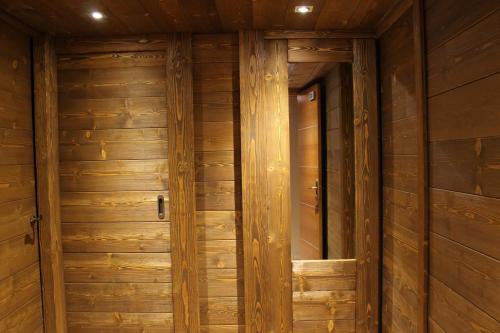 a wooden door in a room with wooden walls at Hostal Piteus in Sant Llorenc de Morunys