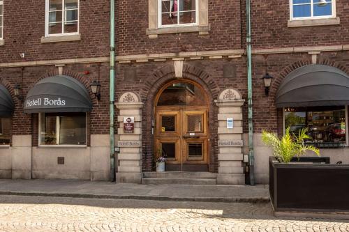 a brick building with an entrance to a store at Hotell Boras, BW Signature Collection in Borås