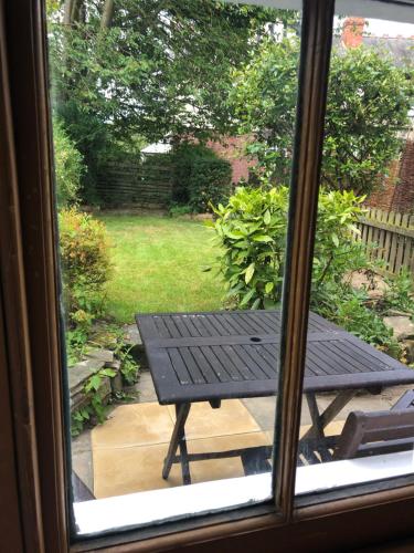 a view of a picnic table from a window at Mole Cottage in Stocksfield