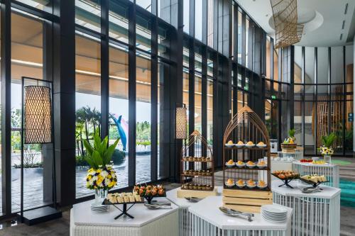 a lobby with tables filled with food and flowers at Holiday Inn Resort Vana Nava Hua Hin, an IHG Hotel in Hua Hin