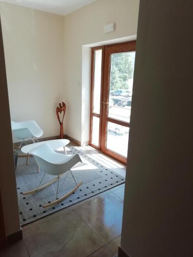 a room with a table and chairs and a window at Penzion Adéla in Rožnov pod Radhoštěm