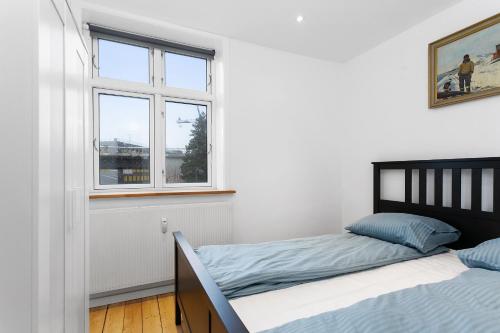 a bedroom with two beds and a window at aday - Apartment suite Aalborg Center in Aalborg