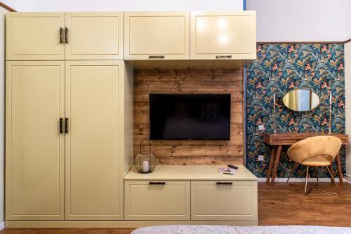 a living room with a white cabinet and a tv at Zur Linde in Sibiu