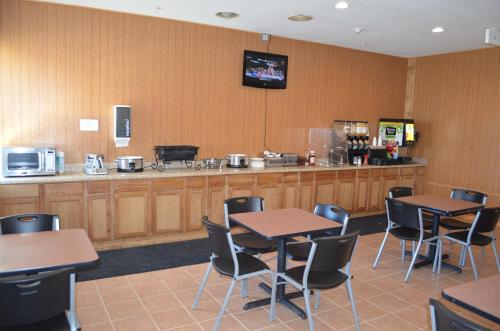 a restaurant with tables and chairs and a counter at Knights Inn Quincy in Quincy