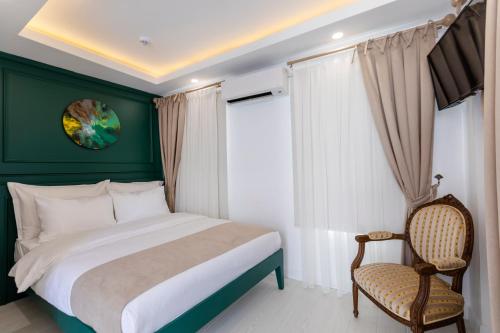 a bedroom with a bed and a chair at KIANA KALEİÇİ in Antalya
