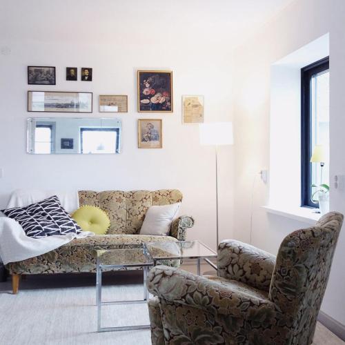a living room with a couch and a chair at Vikens bed and Breakfast in Viken