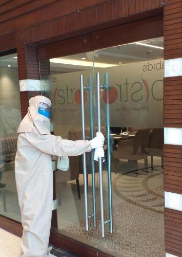 a person standing in front of a store window at Royalton Hyderabad Abids in Hyderabad