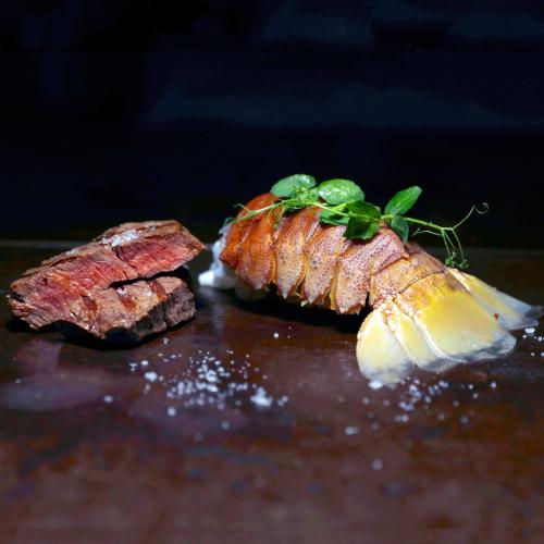 a piece of meat with a green herb on top of it at Guggital Hotel Restaurant in Zug