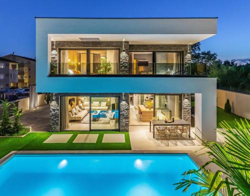a house with a pool in front of it at Superb Design Villa Medulin in Medulin
