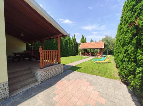 a backyard with a gazebo and a playground at Apollo Vendégház in Bogács