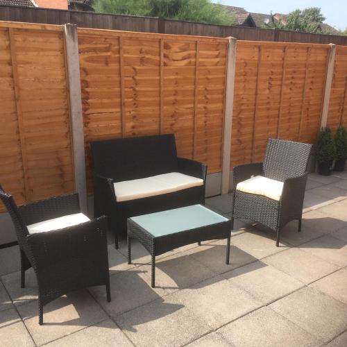 a group of chairs and a table on a patio at Cosy and Peaceful Maisonette with Terrace, Kidderminster in Kidderminster