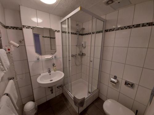 a bathroom with a shower and a sink at Hotel Müller Köln in Cologne