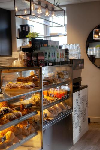 a bakery display case with many different types of pastries at Wilhelmsen House in Tønsberg