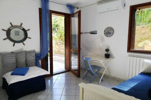 a bedroom with a bed and a desk and a table at Magic Elba & Mindfulness Apartment in Rio nellʼElba