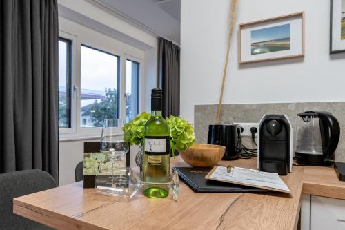 a table with a bottle of wine on top of it at Apartments Galumbo - bleiben & genießen in Illmitz