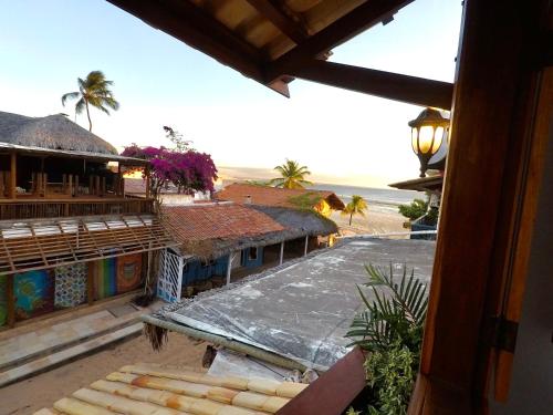 a view of a resort with a beach and a building at Acoara PRAIA in Jericoacoara