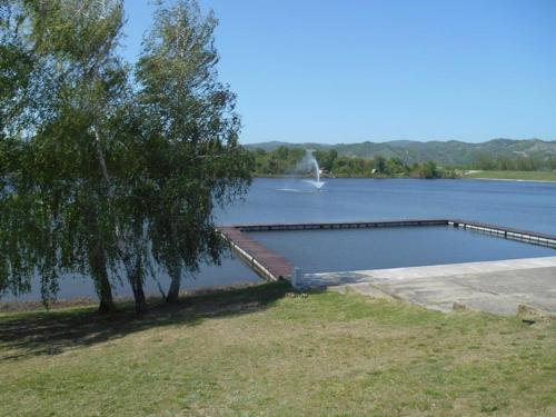 a swimming pool in the middle of a lake at Apartmani Novak - Srebrno jezero in Veliko Gradište