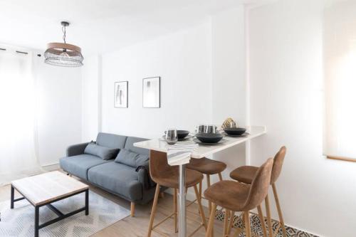 a living room with a table and a couch at Town Hall in Bilbao