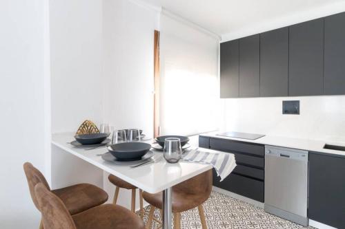 a kitchen with a table and some chairs in it at Town Hall in Bilbao